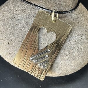Brass and sterling silver pendant